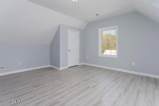 225 Factory Rd, Hampstead, NC 28443 - additional living space with lofted ceiling, wood finished floors, and baseboards