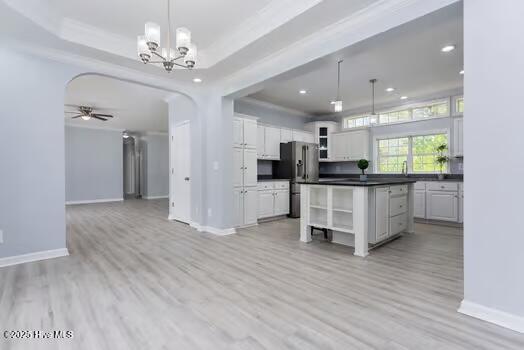 225 Factory Rd, Hampstead, NC 28443 - kitchen with open shelves, stainless steel fridge, dark countertops, baseboards, and white cabinets