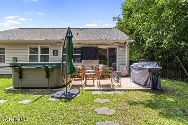1135 Sunburst Way, Leland, NC 28451 - rear view of house featuring a hot tub, a patio area, and roof with shingles