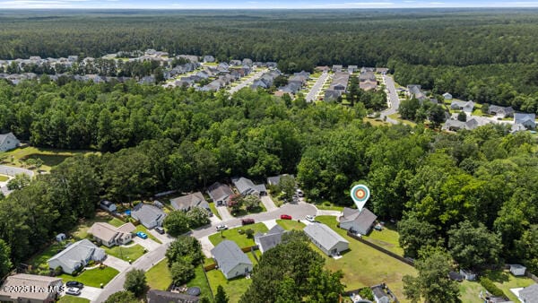 1135 Sunburst Way, Leland, NC 28451 - aerial overview of property's location with a heavily wooded area and nearby suburban area