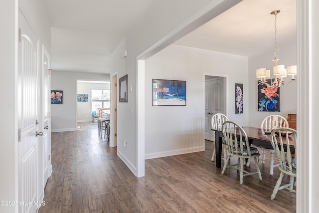 522 Heartwood Dr, Leland, NC 28479 - dining area featuring a chandelier, dark wood finished floors, and baseboards