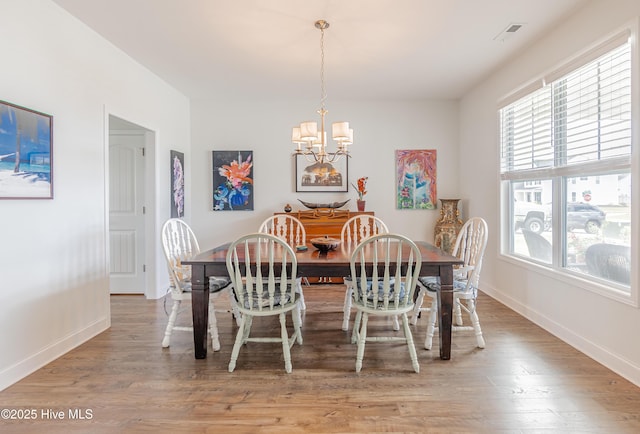 522 Heartwood Dr, Leland, NC 28479 - dining space with a chandelier, light wood-type flooring, and baseboards