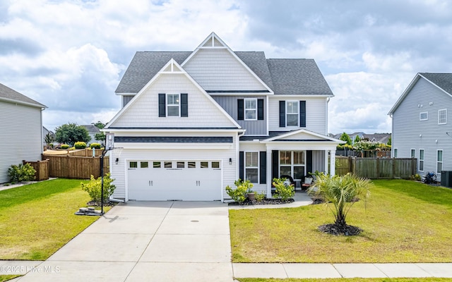 522 Heartwood Dr, Leland, NC 28479 - view of front facade featuring concrete driveway, a garage, covered porch, roof with shingles, and central AC