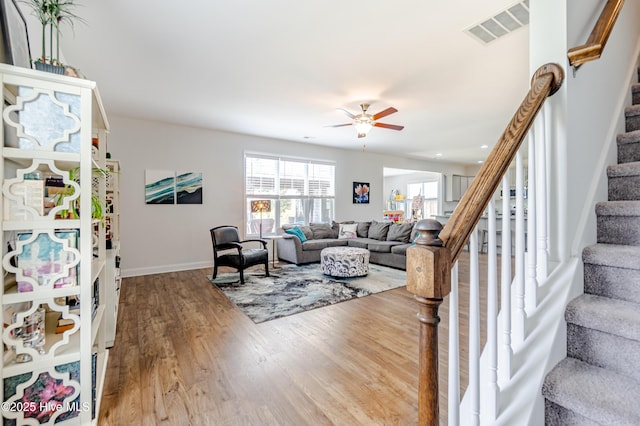 522 Heartwood Dr, Leland, NC 28479 - living room featuring stairs, wood finished floors, a ceiling fan, and baseboards