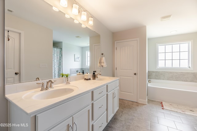 522 Heartwood Dr, Leland, NC 28479 - full bathroom with double vanity, plenty of natural light, a bath, and tile patterned flooring