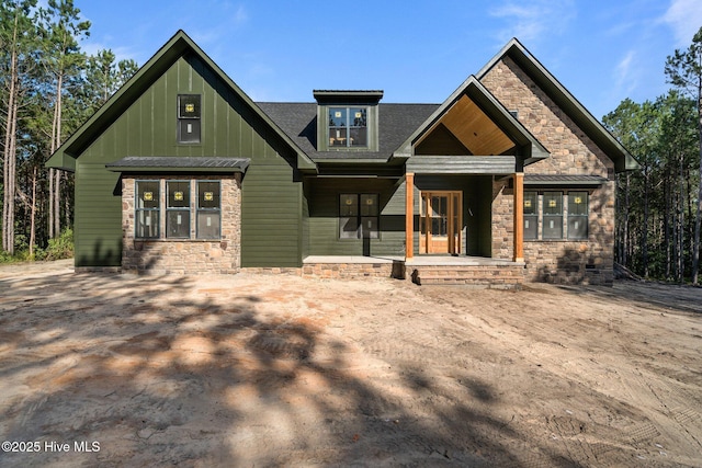 445 Oldham Rd, West End, NC 27376 - craftsman-style home with stone siding, board and batten siding, and a porch
