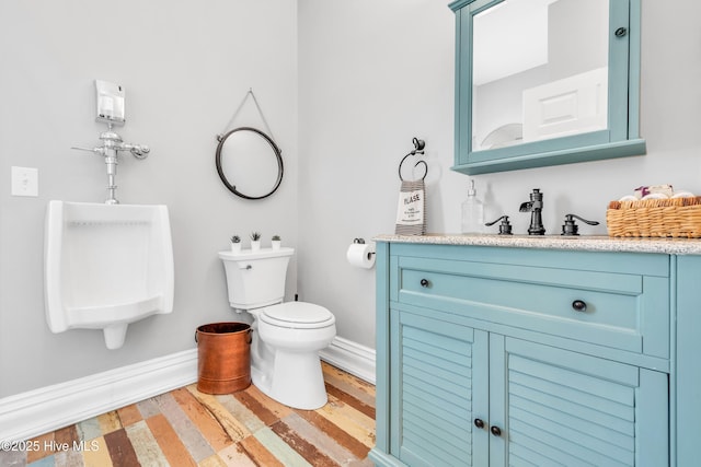 414 Yaupon Dr, Southport, NC 28461 - bathroom featuring toilet, a sink, wood finished floors, and baseboards