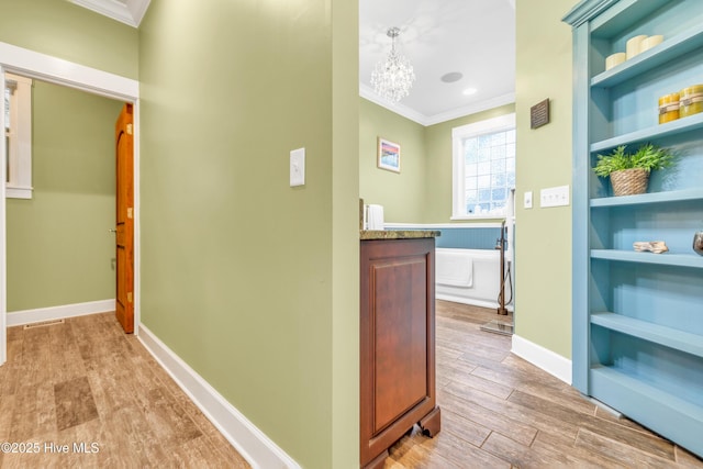 414 Yaupon Dr, Southport, NC 28461 - hall with crown molding, a chandelier, wood finished floors, and baseboards