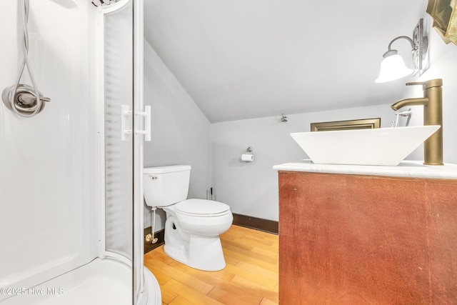 414 Yaupon Dr, Southport, NC 28461 - full bath with lofted ceiling, a shower stall, wood finished floors, a sink, and toilet
