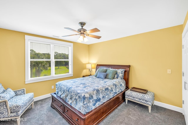 414 Yaupon Dr, Southport, NC 28461 - bedroom featuring dark carpet, baseboards, and a ceiling fan