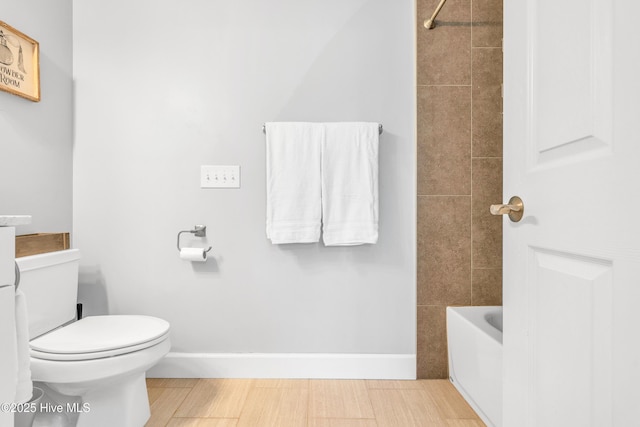 414 Yaupon Dr, Southport, NC 28461 - bathroom featuring toilet, baseboards, and wood finished floors