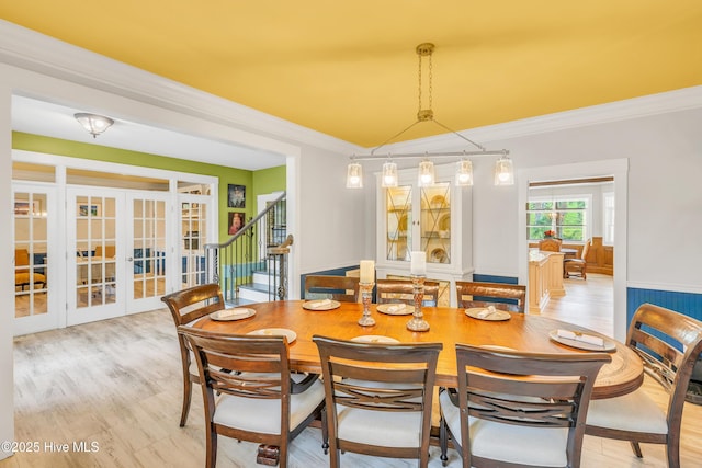 414 Yaupon Dr, Southport, NC 28461 - dining area featuring french doors, ornamental molding, light wood-style flooring, and stairway