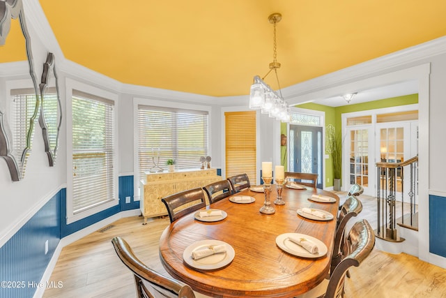 414 Yaupon Dr, Southport, NC 28461 - dining space with light wood finished floors, french doors, healthy amount of natural light, and crown molding