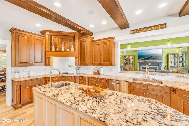 414 Yaupon Dr, Southport, NC 28461 - kitchen featuring a sink, beamed ceiling, dishwasher, light wood-style floors, and light stone counters