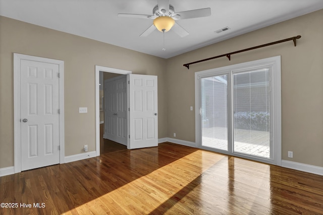 5622 Shell Road Village Dr, Wilmington, NC 28403 - unfurnished bedroom featuring access to outside, wood finished floors, and baseboards