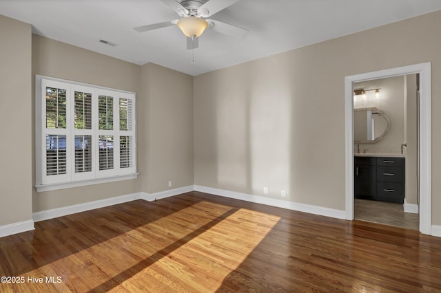 5622 Shell Road Village Dr, Wilmington, NC 28403 - spare room featuring wood finished floors, a ceiling fan, and baseboards