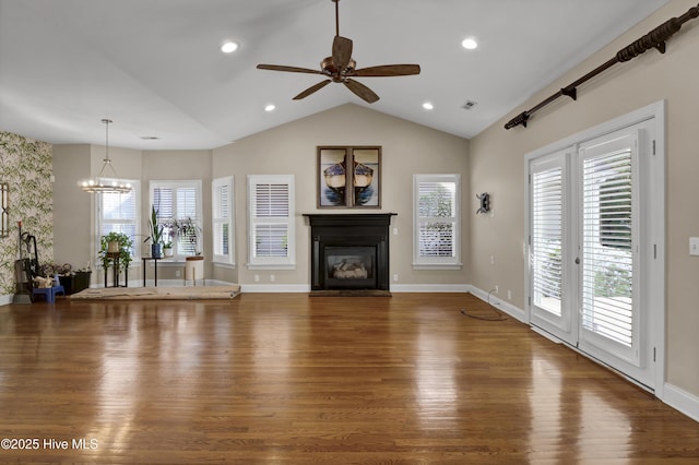 5622 Shell Road Village Dr, Wilmington, NC 28403 - living room featuring lofted ceiling, a glass covered fireplace, wood finished floors, a chandelier, and a ceiling fan