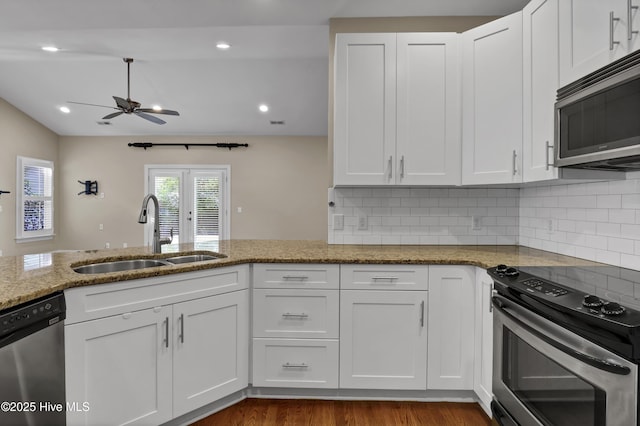 5622 Shell Road Village Dr, Wilmington, NC 28403 - kitchen with stainless steel appliances, a sink, ceiling fan, light stone counters, and white cabinets