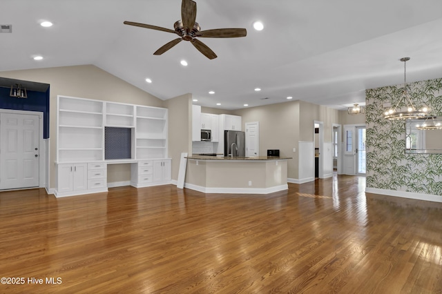 5622 Shell Road Village Dr, Wilmington, NC 28403 - unfurnished living room featuring a chandelier, a ceiling fan, wood finished floors, lofted ceiling, and baseboards