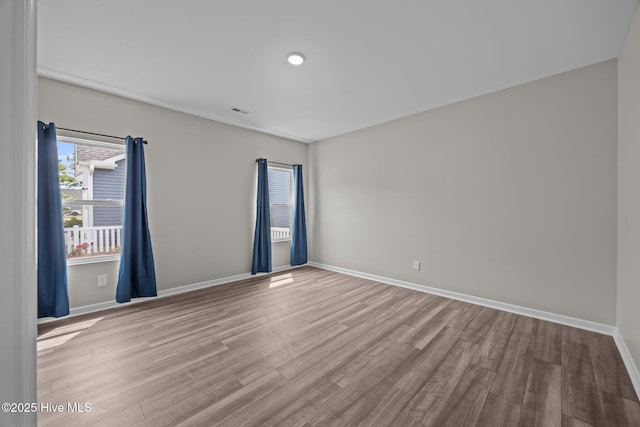 1008 Rodanthe Dr, New Bern, NC 28562 - unfurnished room with wood finished floors, baseboards, and recessed lighting
