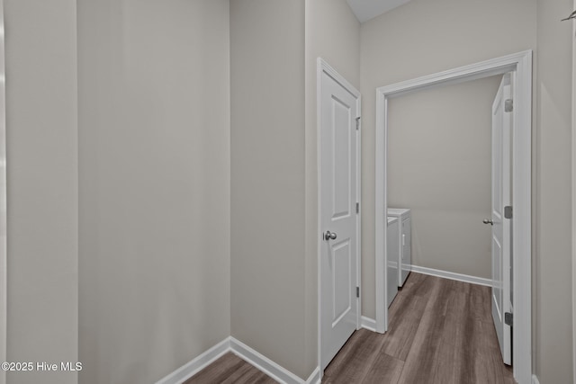 1008 Rodanthe Dr, New Bern, NC 28562 - hallway with washer and dryer, dark wood-style flooring, and baseboards