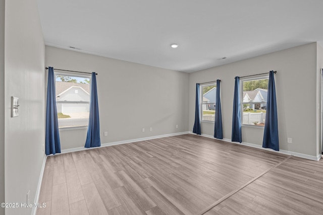 1008 Rodanthe Dr, New Bern, NC 28562 - empty room with plenty of natural light, wood finished floors, and baseboards