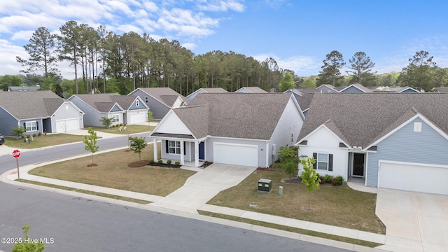 1008 Rodanthe Dr, New Bern, NC 28562 - traditional-style house with driveway, a front lawn, a residential view, an attached garage, and roof with shingles