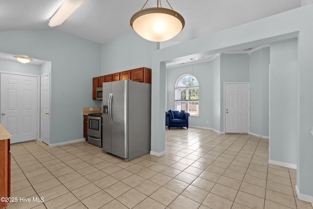 1001 Windgate Dr, Wilmington, NC 28412 - kitchen with stainless steel appliances, lofted ceiling, light tile patterned flooring, light countertops, and baseboards