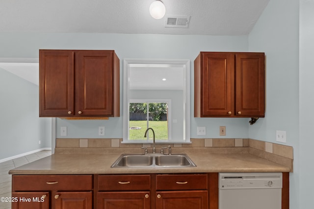 1001 Windgate Dr, Wilmington, NC 28412 - kitchen with white dishwasher, a sink, light countertops, and a textured ceiling