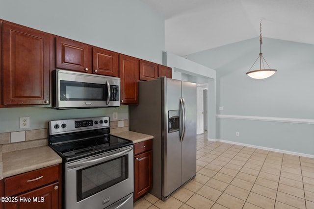 1001 Windgate Dr, Wilmington, NC 28412 - kitchen featuring stainless steel appliances, light countertops, light tile patterned floors, vaulted ceiling, and pendant lighting