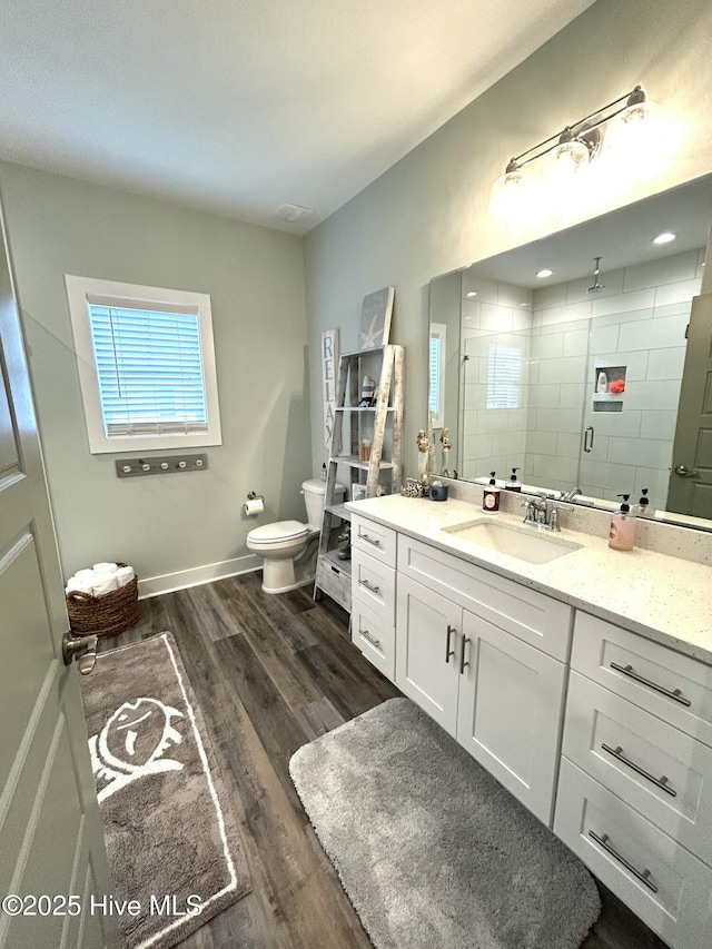 429 Island Creek Rd, Rocky Point, NC 28457 - full bathroom with wood finished floors, vanity, a stall shower, toilet, and baseboards