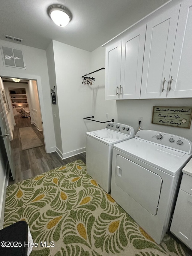 429 Island Creek Rd, Rocky Point, NC 28457 - laundry room featuring cabinet space, washer and clothes dryer, dark wood-type flooring, and baseboards