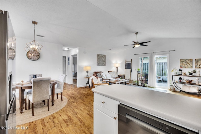 222 Bridgeton Ct, Wilmington, NC 28411 - kitchen featuring appliances with stainless steel finishes, light wood-style floors, white cabinetry, a ceiling fan, and lofted ceiling