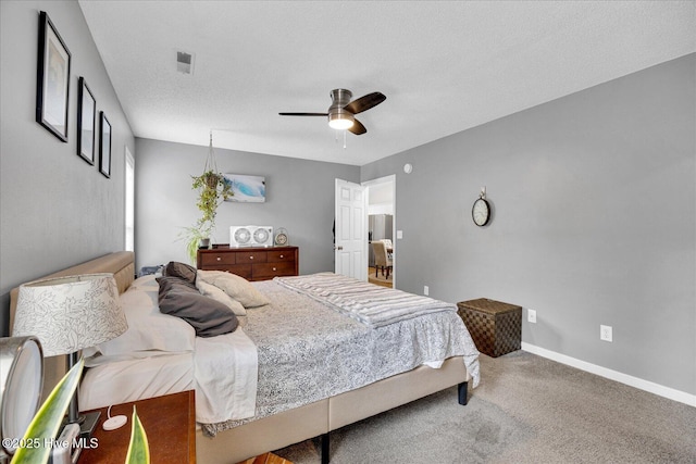 222 Bridgeton Ct, Wilmington, NC 28411 - carpeted bedroom featuring a ceiling fan, baseboards, and a textured ceiling