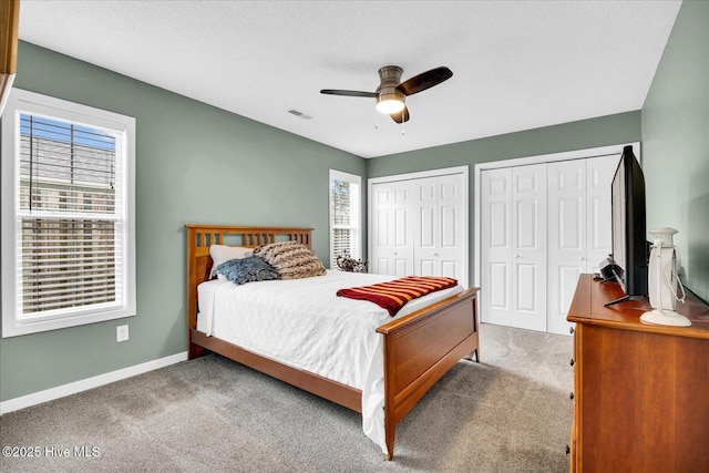 222 Bridgeton Ct, Wilmington, NC 28411 - carpeted bedroom with two closets, baseboards, ceiling fan, and a textured ceiling