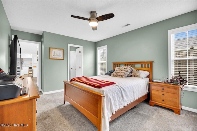 222 Bridgeton Ct, Wilmington, NC 28411 - bedroom with light carpet, multiple windows, baseboards, and ceiling fan