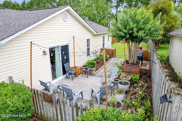 222 Bridgeton Ct, Wilmington, NC 28411 - back of house featuring roof with shingles, a patio, and a fenced backyard