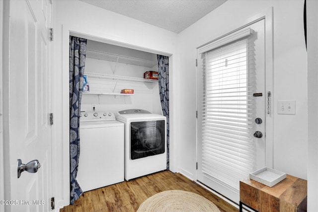 222 Bridgeton Ct, Wilmington, NC 28411 - laundry room featuring washer and dryer, light wood-style floors, and a textured ceiling