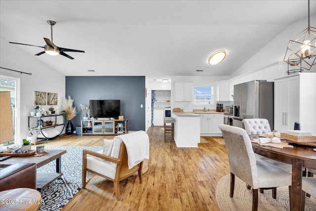 222 Bridgeton Ct, Wilmington, NC 28411 - living room with a chandelier, light wood finished floors, a ceiling fan, and high vaulted ceiling