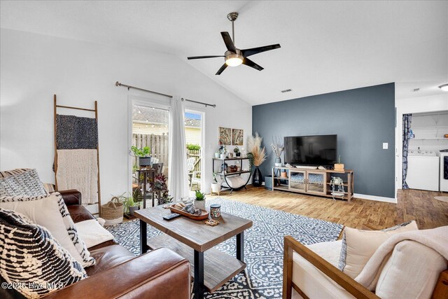 222 Bridgeton Ct, Wilmington, NC 28411 - living room featuring a ceiling fan, washing machine and clothes dryer, wood finished floors, lofted ceiling, and baseboards
