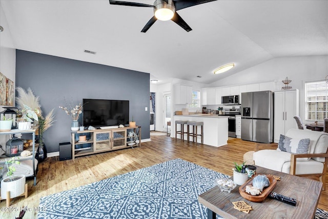 222 Bridgeton Ct, Wilmington, NC 28411 - living room with vaulted ceiling, a ceiling fan, light wood-style flooring, and baseboards