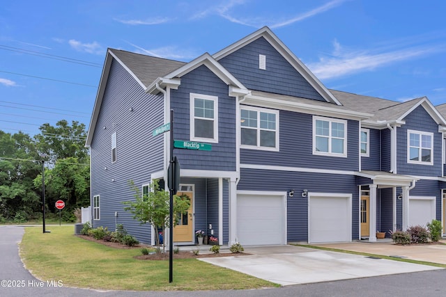 6751 Blacktip Ln, Wilmington, NC 28412 - view of property featuring a garage, concrete driveway, and a front yard