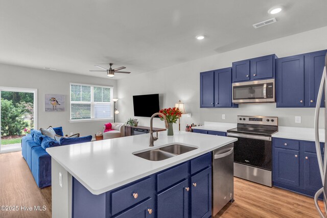 6751 Blacktip Ln, Wilmington, NC 28412 - kitchen featuring appliances with stainless steel finishes, open floor plan, blue cabinetry, and recessed lighting