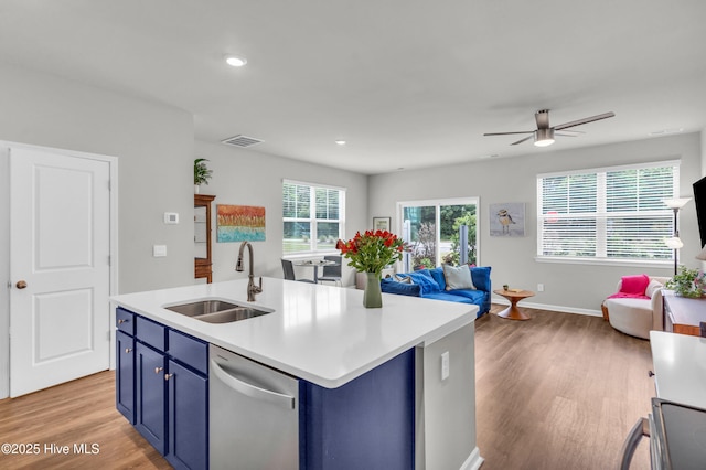 6751 Blacktip Ln, Wilmington, NC 28412 - kitchen featuring dishwasher, blue cabinetry, open floor plan, light countertops, and recessed lighting