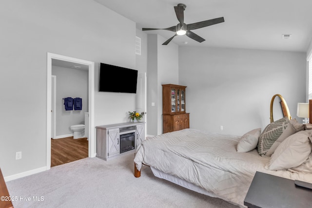 6751 Blacktip Ln, Wilmington, NC 28412 - bedroom featuring carpet flooring, high vaulted ceiling, a glass covered fireplace, ensuite bath, and ceiling fan