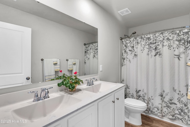 6751 Blacktip Ln, Wilmington, NC 28412 - bathroom with double vanity, wood finished floors, and a shower with curtain