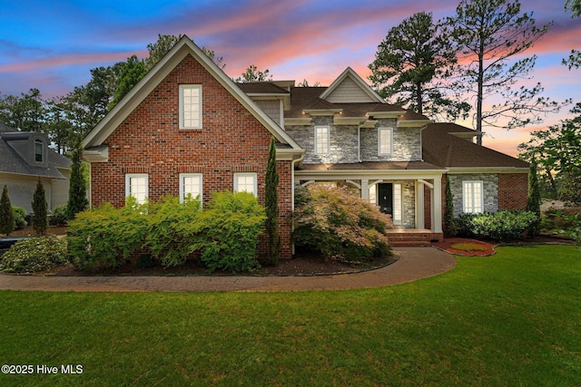 30 Spring Valley Ct, Pinehurst, NC 28374 - view of front of home featuring a lawn, stone siding, and brick siding