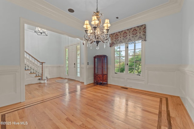30 Spring Valley Ct, Pinehurst, NC 28374 - foyer with a chandelier, stairway, crown molding, a wainscoted wall, and wood finished floors