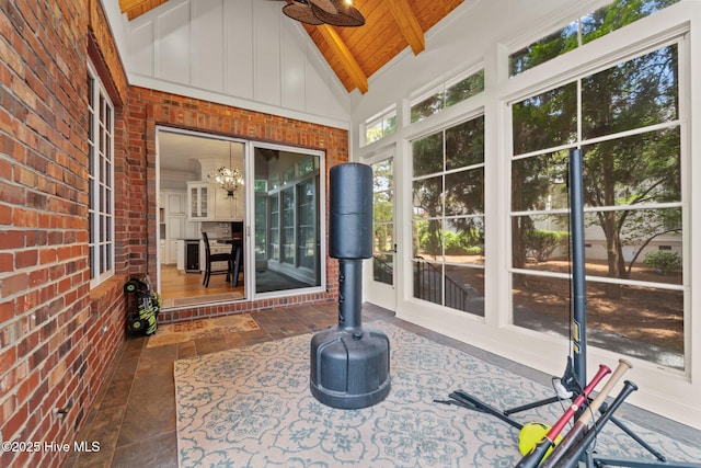 30 Spring Valley Ct, Pinehurst, NC 28374 - sunroom featuring brick wall, ceiling fan, a wood ceiling with exposed beams, high vaulted ceiling, and stone finish floors