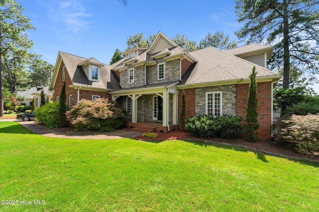 30 Spring Valley Ct, Pinehurst, NC 28374 - view of front of property featuring stone siding, a front yard, a shingled roof, and a porch